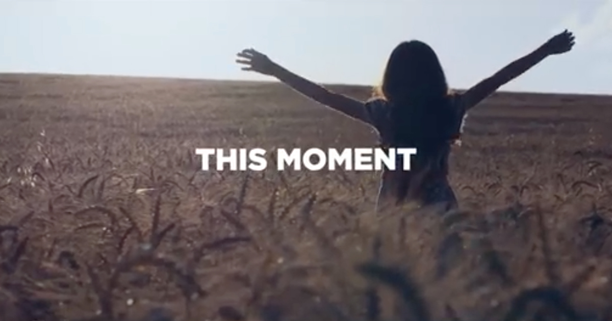 Young girl in field with "this moment" supered