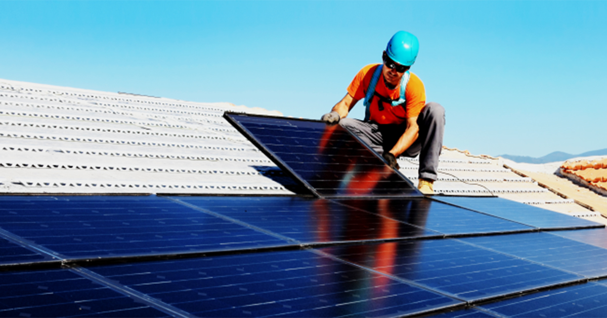 Worker installs solar panels