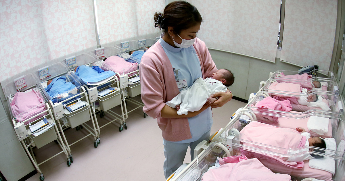 nurse tends babies in Japanese nursery